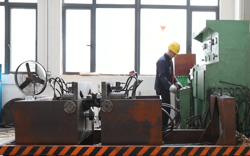 Technician performing strict hydrostatic and pneumatic pressure testing on industrial valves at BSO Fluid Control factory