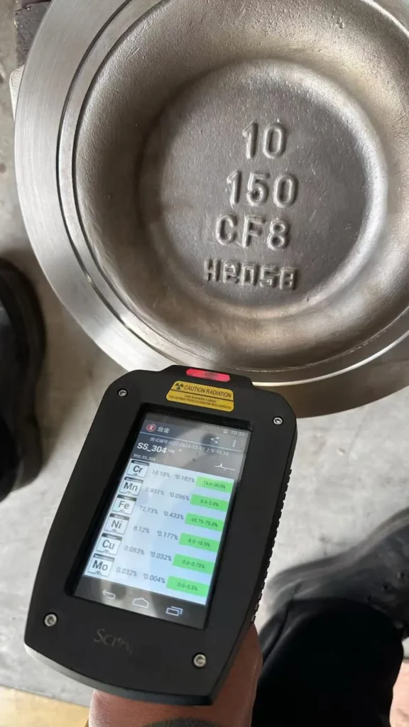 Handheld PMI spectrometer analysis on a stainless steel valve body for material chemistry verification at Ball Seal Valve factory.