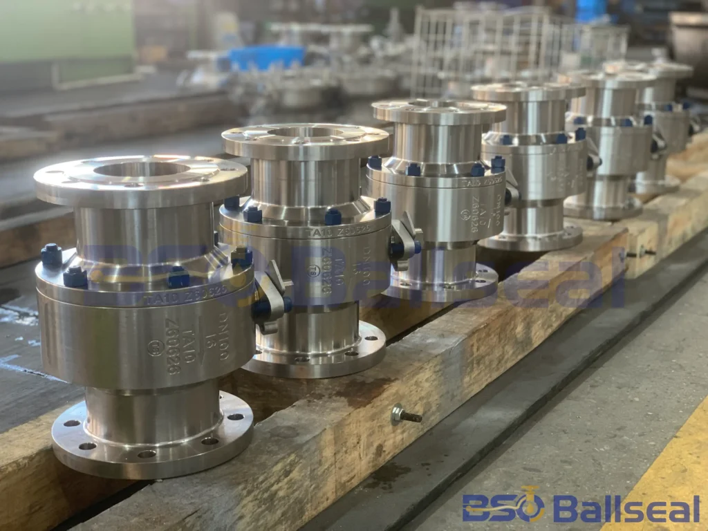A row of TA10 titanium alloy flanged ball valves DN100 PN16 on a wooden pallet inside the BSO Ballseal factory